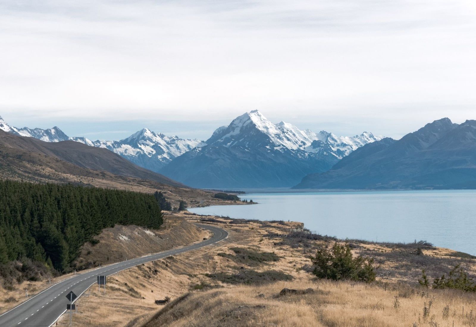State Highway 80 winds alongside Lake Pukaki towards the snow-capped peak of Mount Cook in the distance.